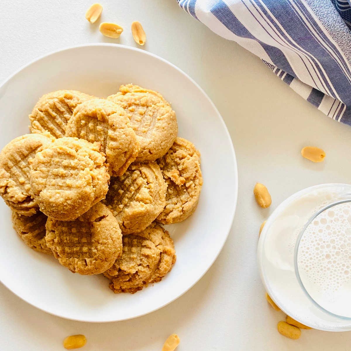almond flour peanut butter cookies on plate next to glass of milk