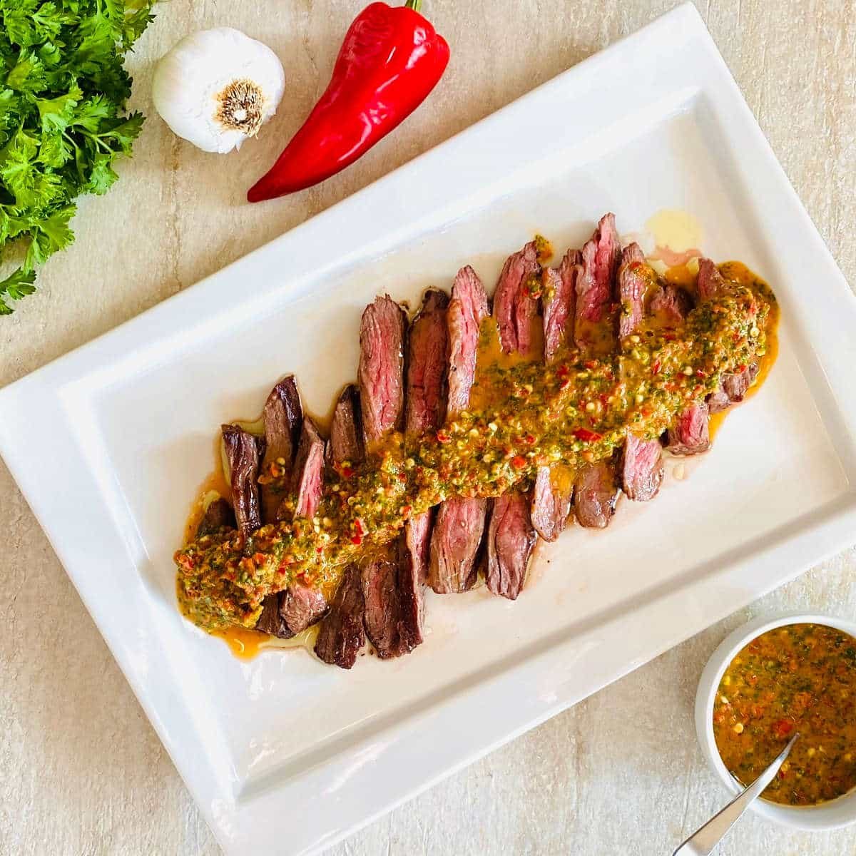 red chimichurri sauce on sliced steak
