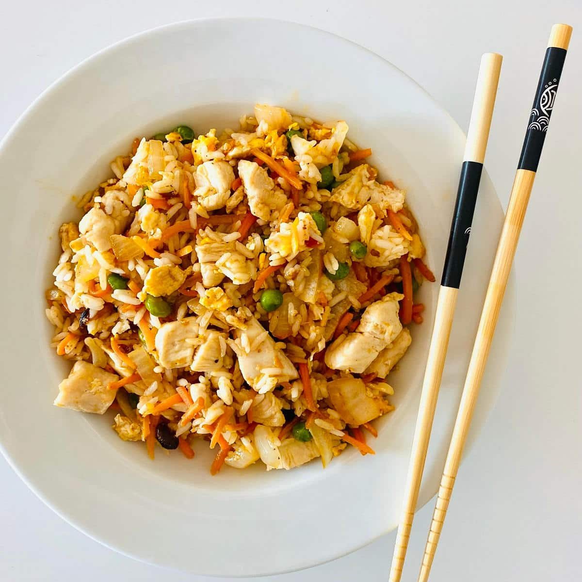 griddle fried rice in bowl with chopsticks.