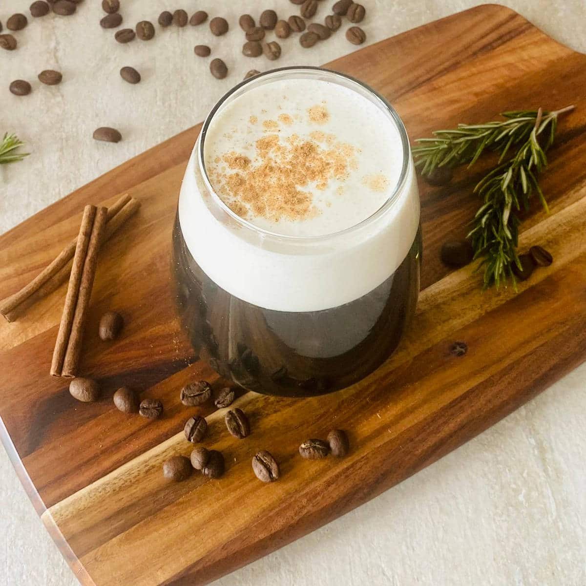 brown sugar simple syrup in a coffee surrounded by coffee beans