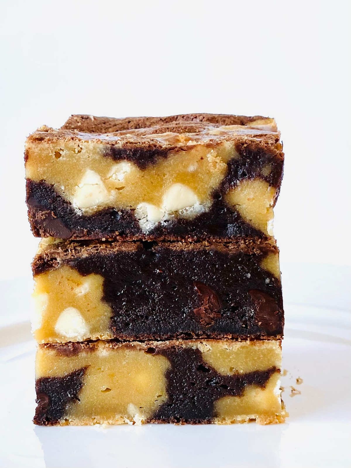 brown and blonde brownies in a stack