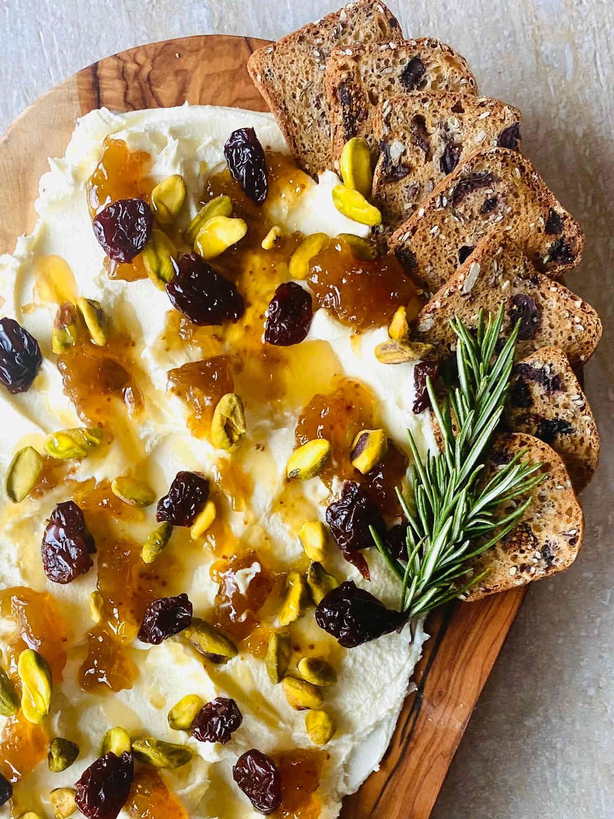 mascarpone butter board with mascarpone cheese, dried cherries, pistachios, fig jam and honey.