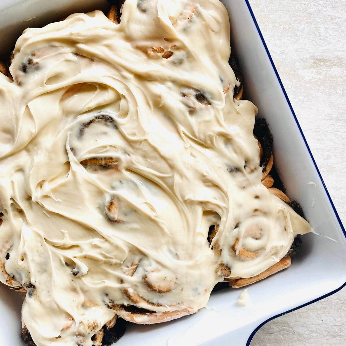 cinnamon rolls topped with cream cheese icing.
