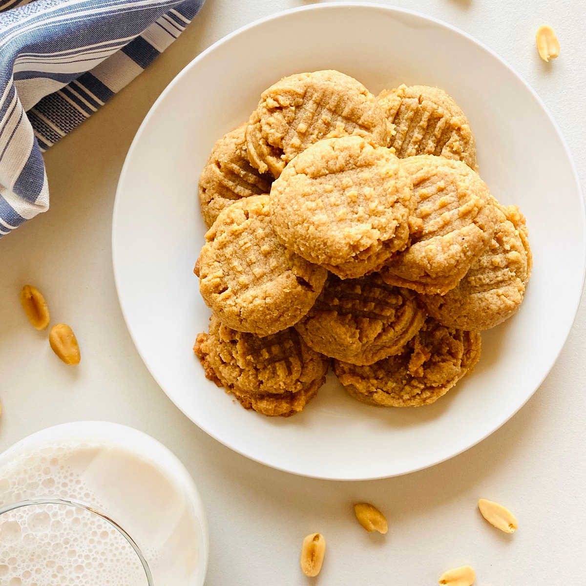 almond flour peanut butter cookies on plate next to glass of milk