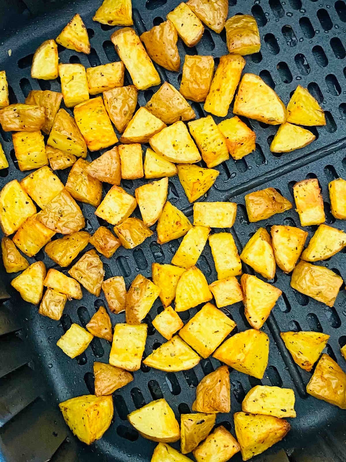 cubed potatoes in air fryer basket