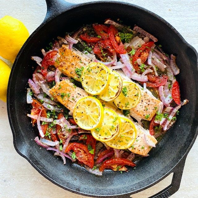 Easy-Baked-Salmon-in-skillet-next-to-lemon