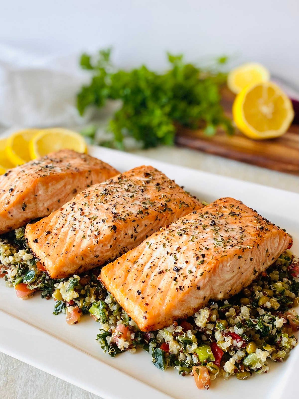grilled faroe island salmon filets on a bed of green salad