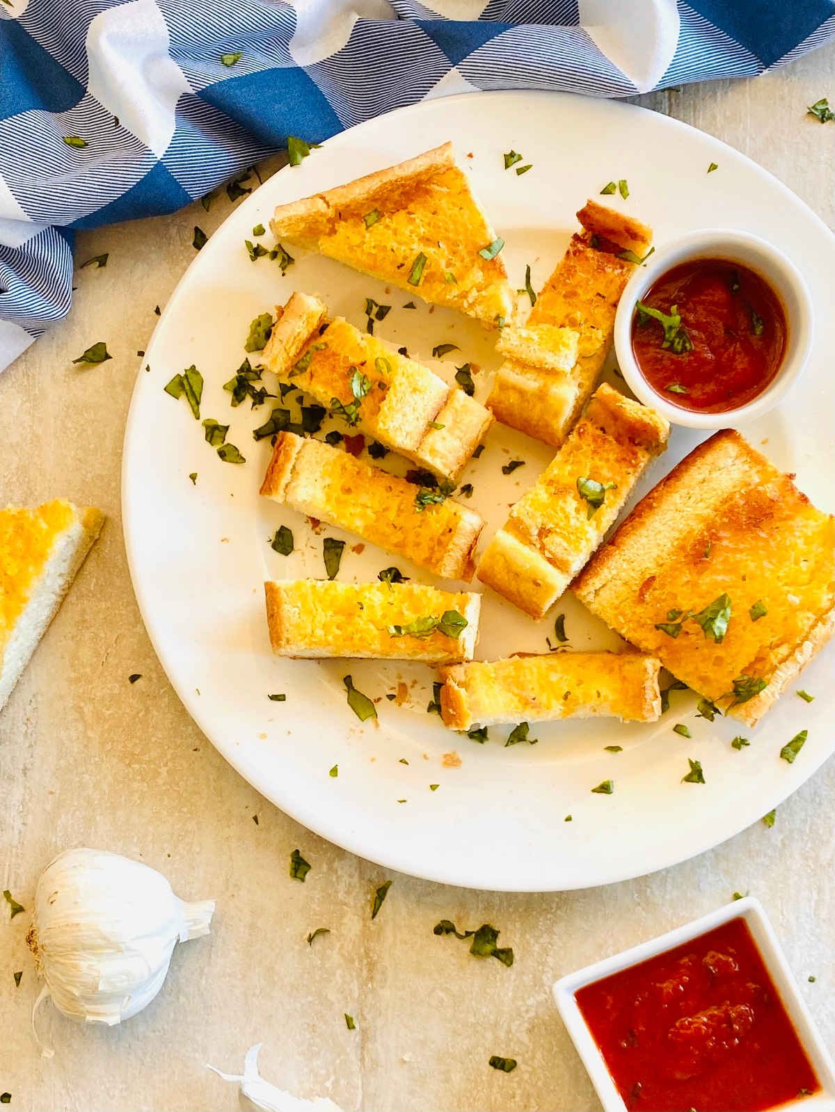 frozen texas toast cooked in air fryer on a plate next to marinara