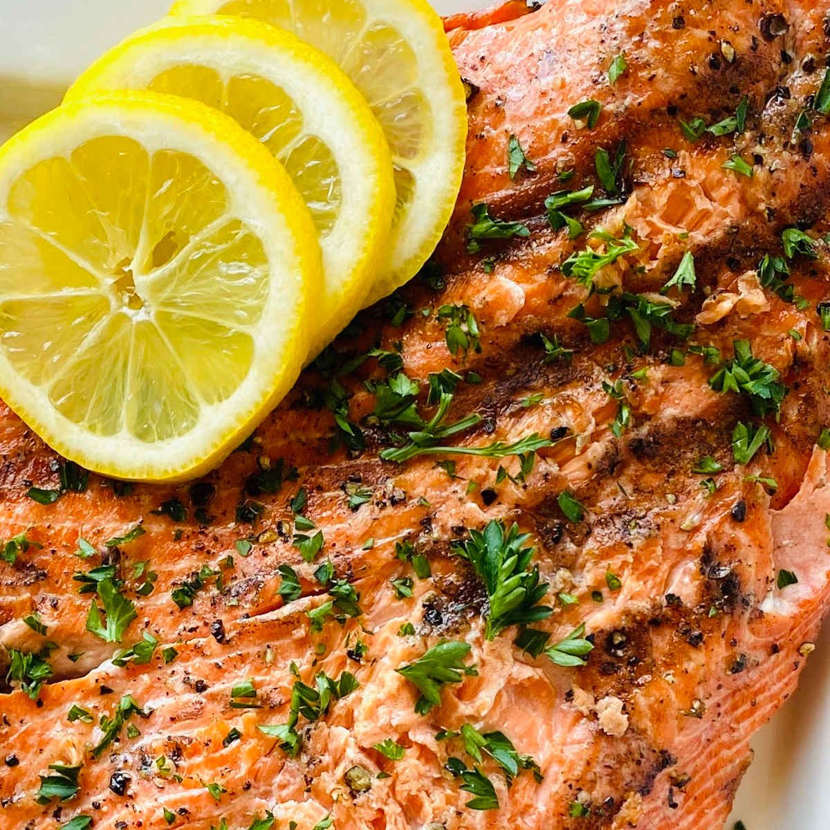grilled wild caught sockeye salmon garnished with lemon and parsley