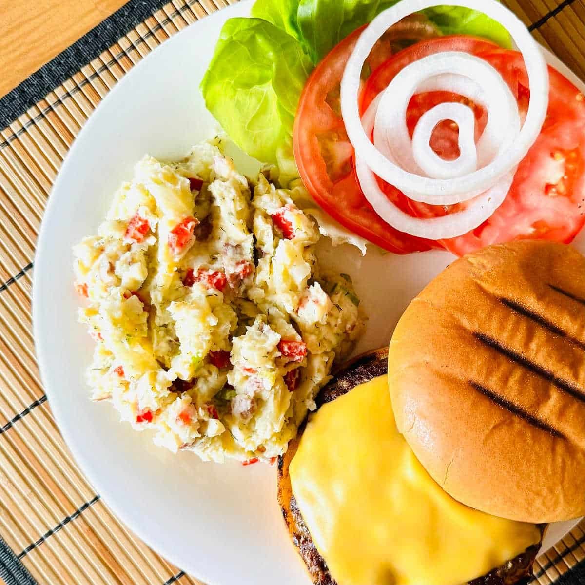 healthy potato salad recipe no mayo on plate with hamburger.