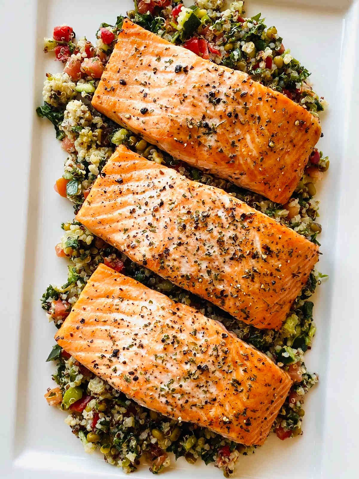 baked faroe island salmon on a plate over quinoa.