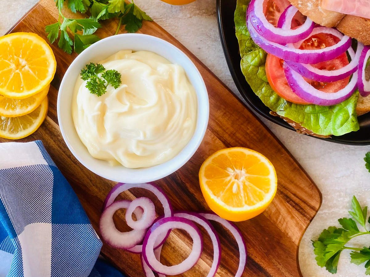 homemade mayonaise recipe in a bowl garnished with parsley.