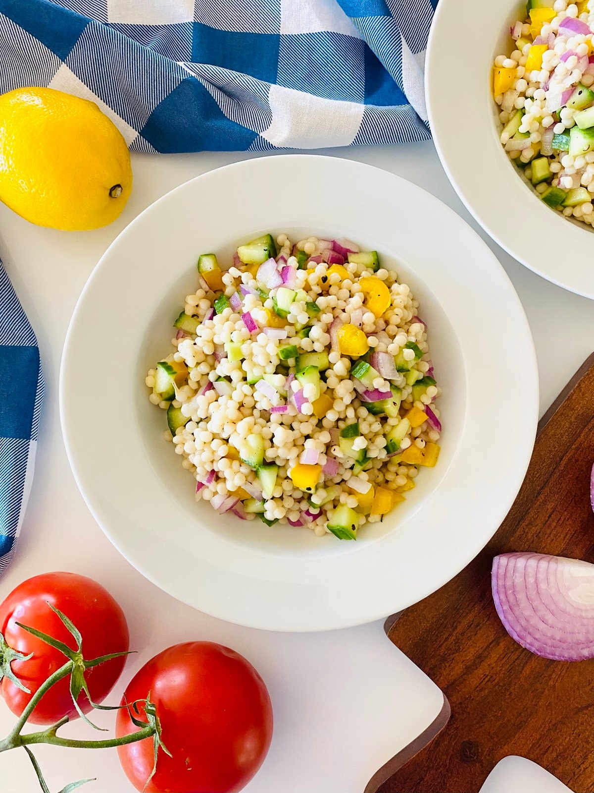 instant pot couscous in a bowl with fresh chopped vegetables