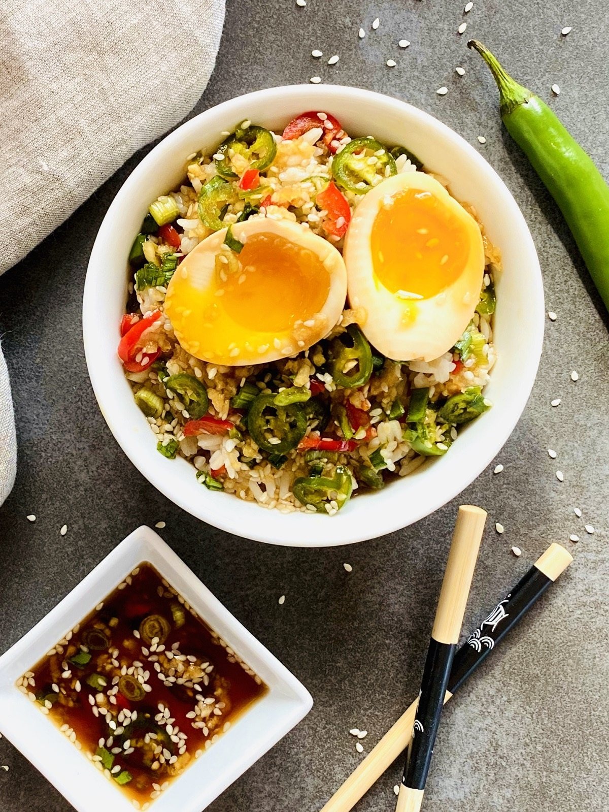bowl of soft boiled marinated korean soy mayak eggs next to chopsticks and dipping sauce
