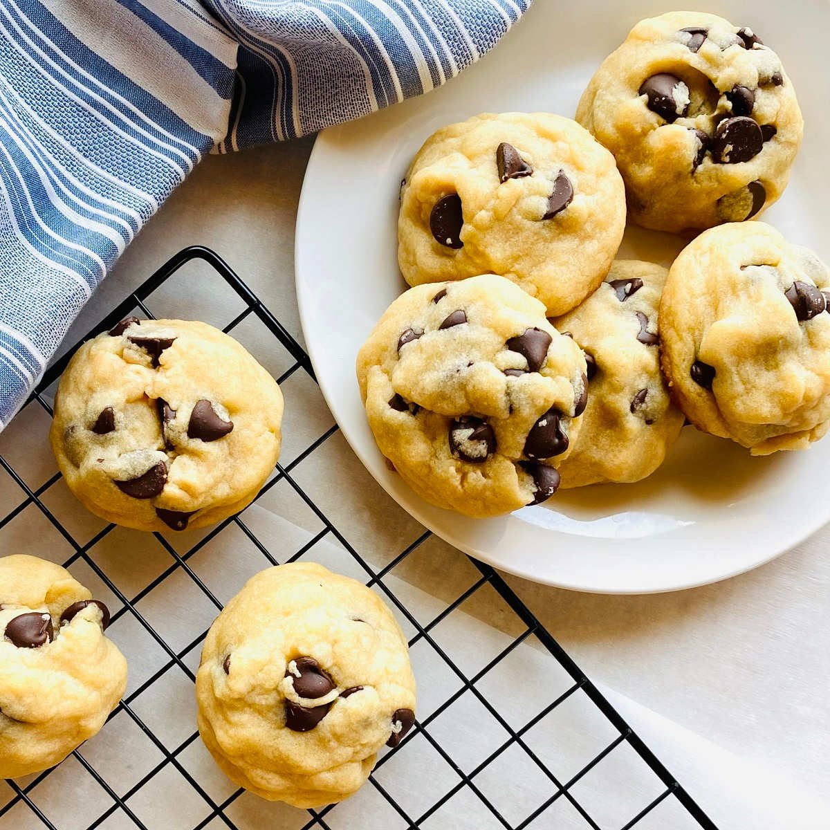 chocolate chip cookies no brown sugar on plate next to cooling rack with cookies