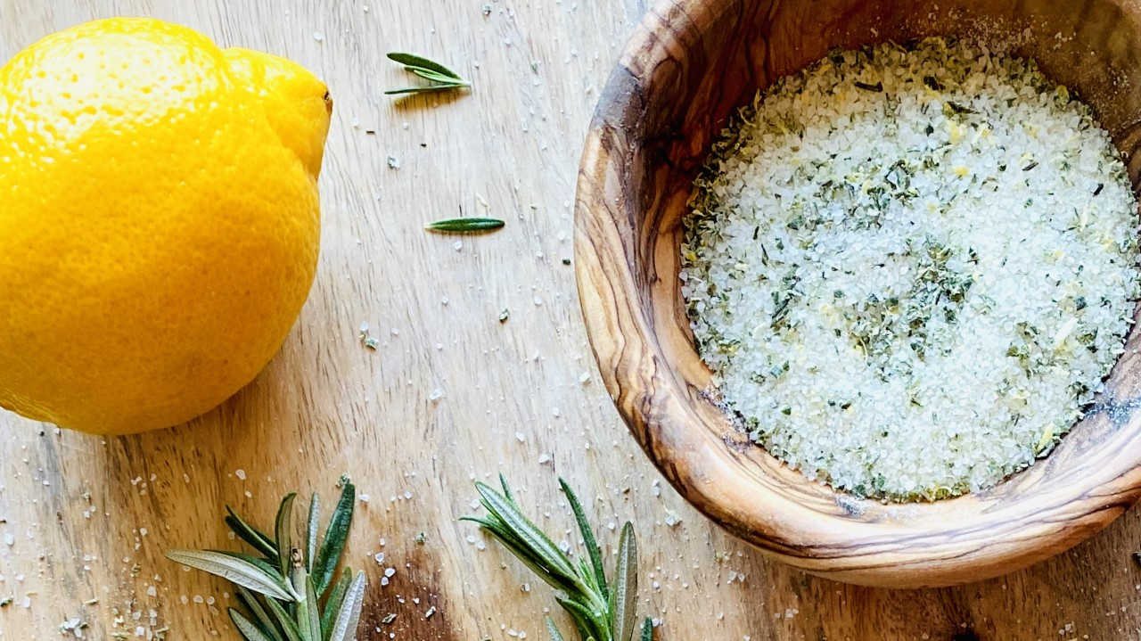 Rosemary salt in bowl next to lemon and rosemary