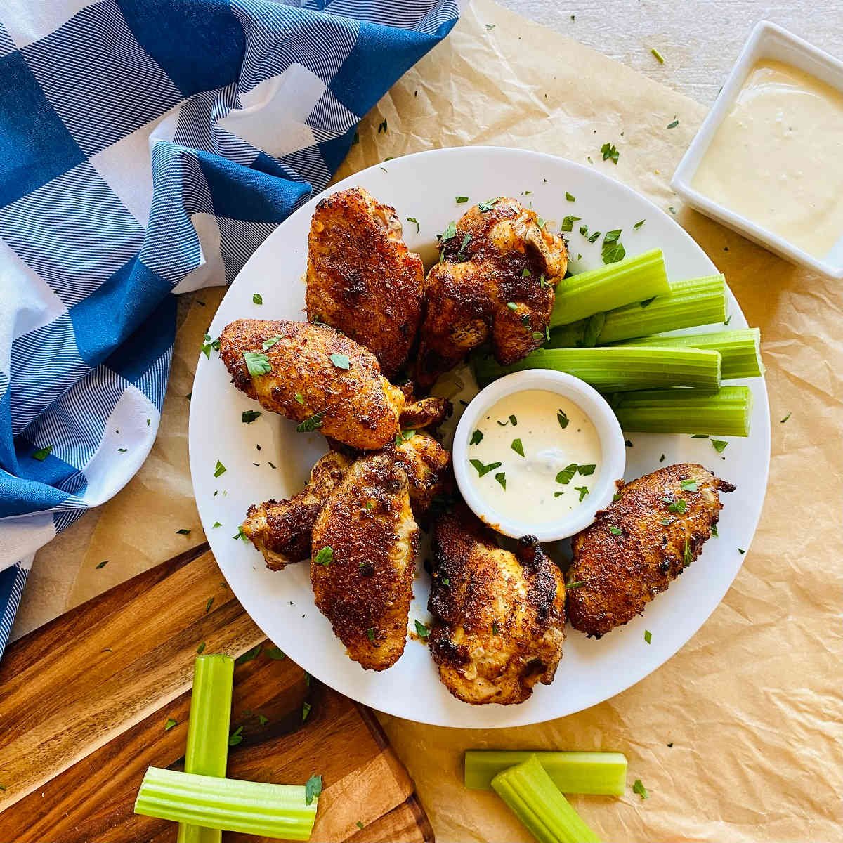 cajun wings recipe on a plate with celery and dip