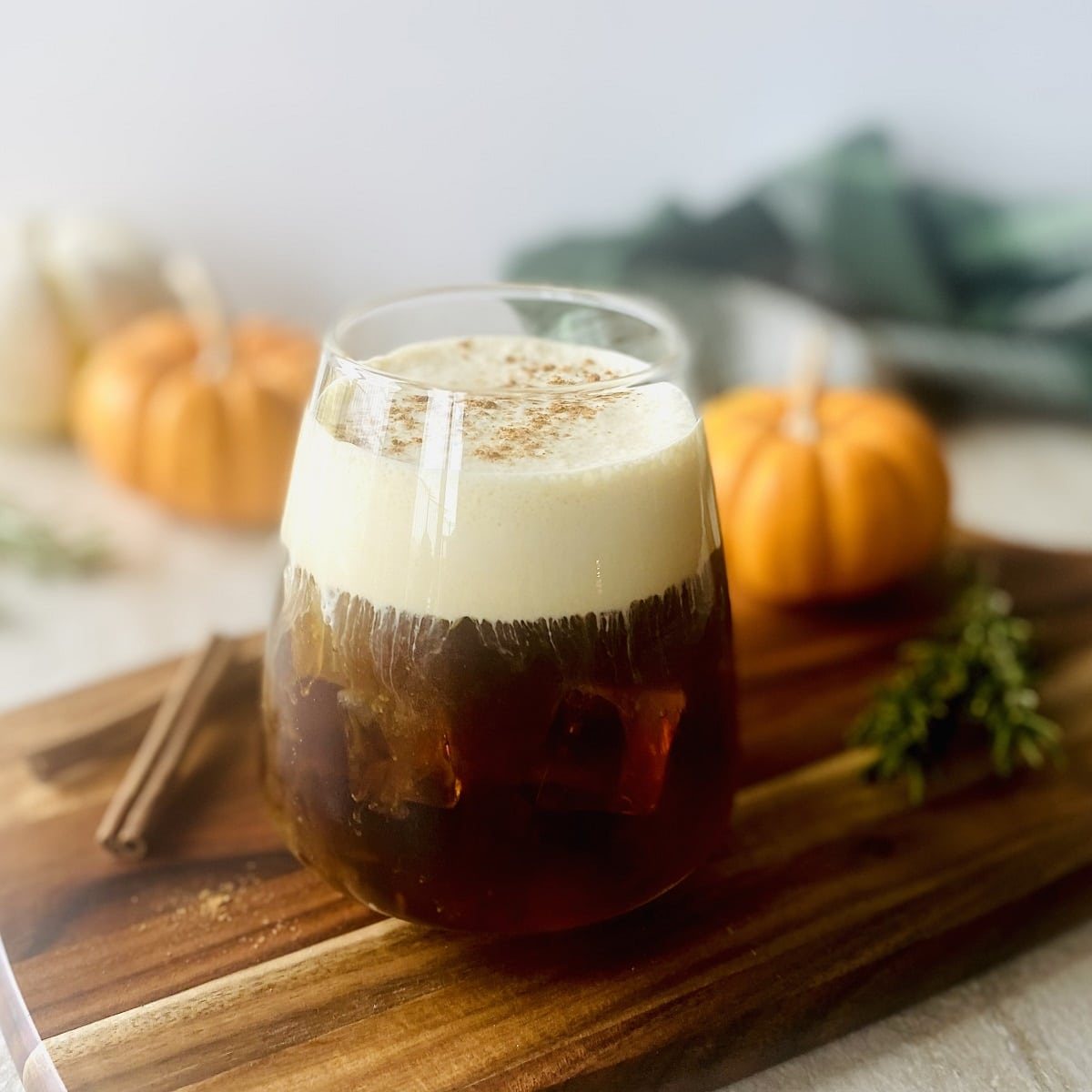 starbucks pumpkin cream cold brew coffee with pumpkins in background.
