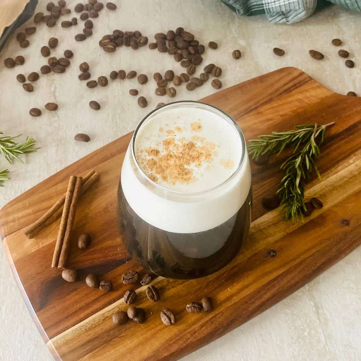brown sugar simple syrup in a coffee surrounded by coffee beans