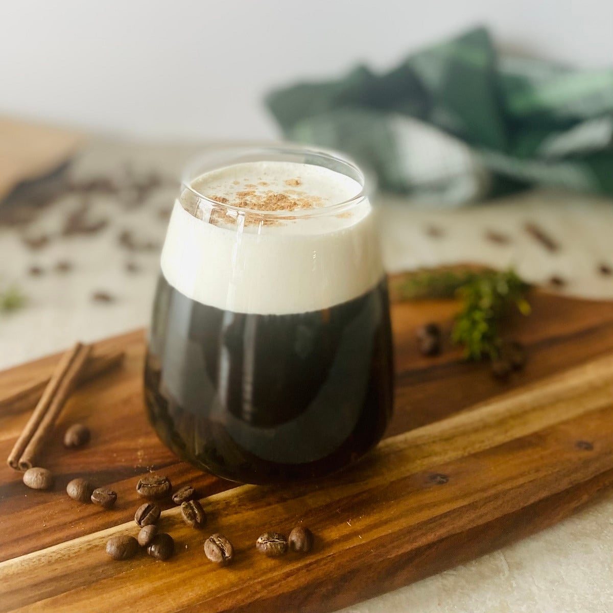 starbucks vanilla sweet cream cold brew on a wooden board with coffee beans.