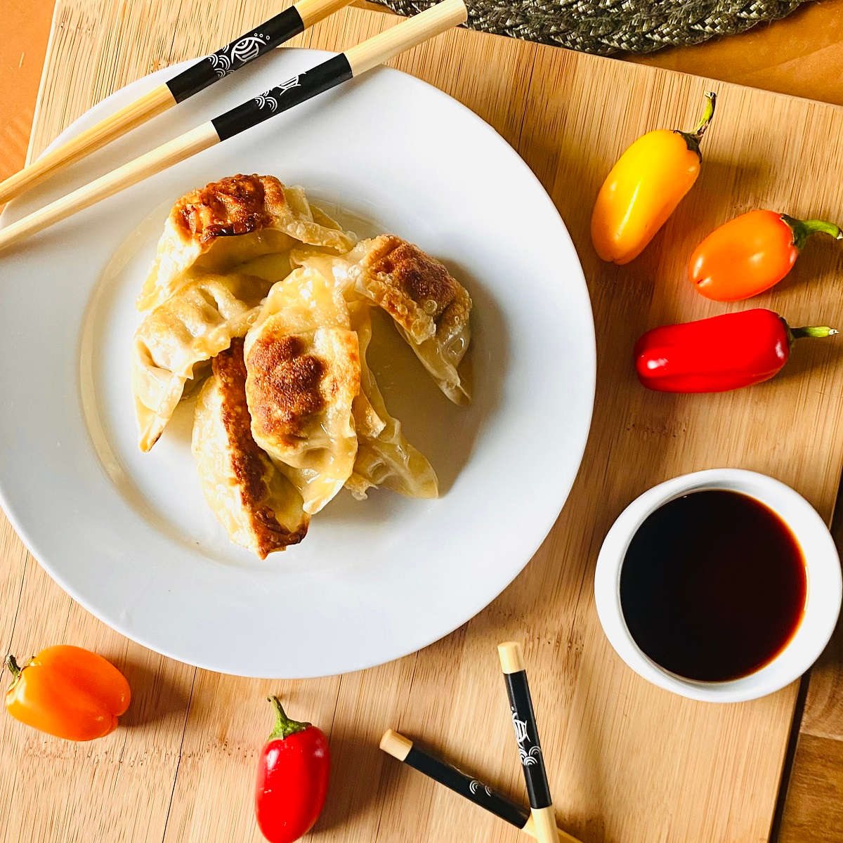 air fryer frozen potstickers cooked on a plate with chopsticks and soy sauce
