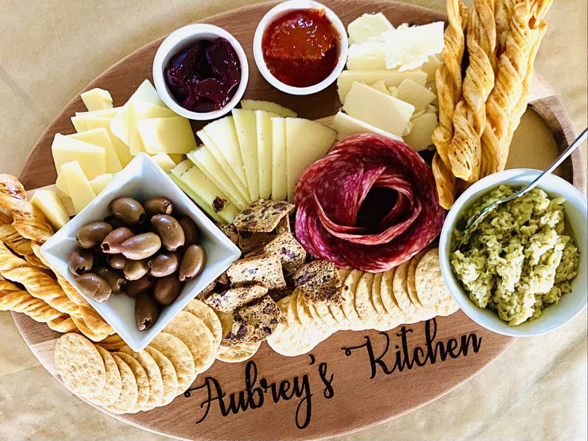 charcuterie with salami rose, olives, meats cheese, dips and artichoke spread