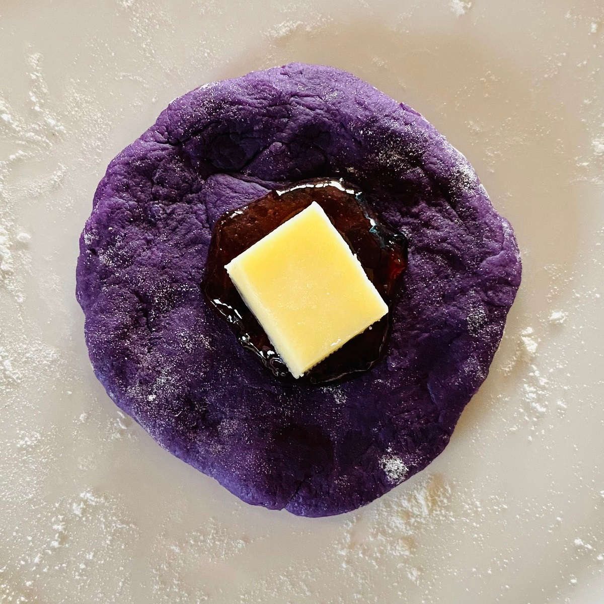ube cheese pandesal dough with halaya jam and cheese on top