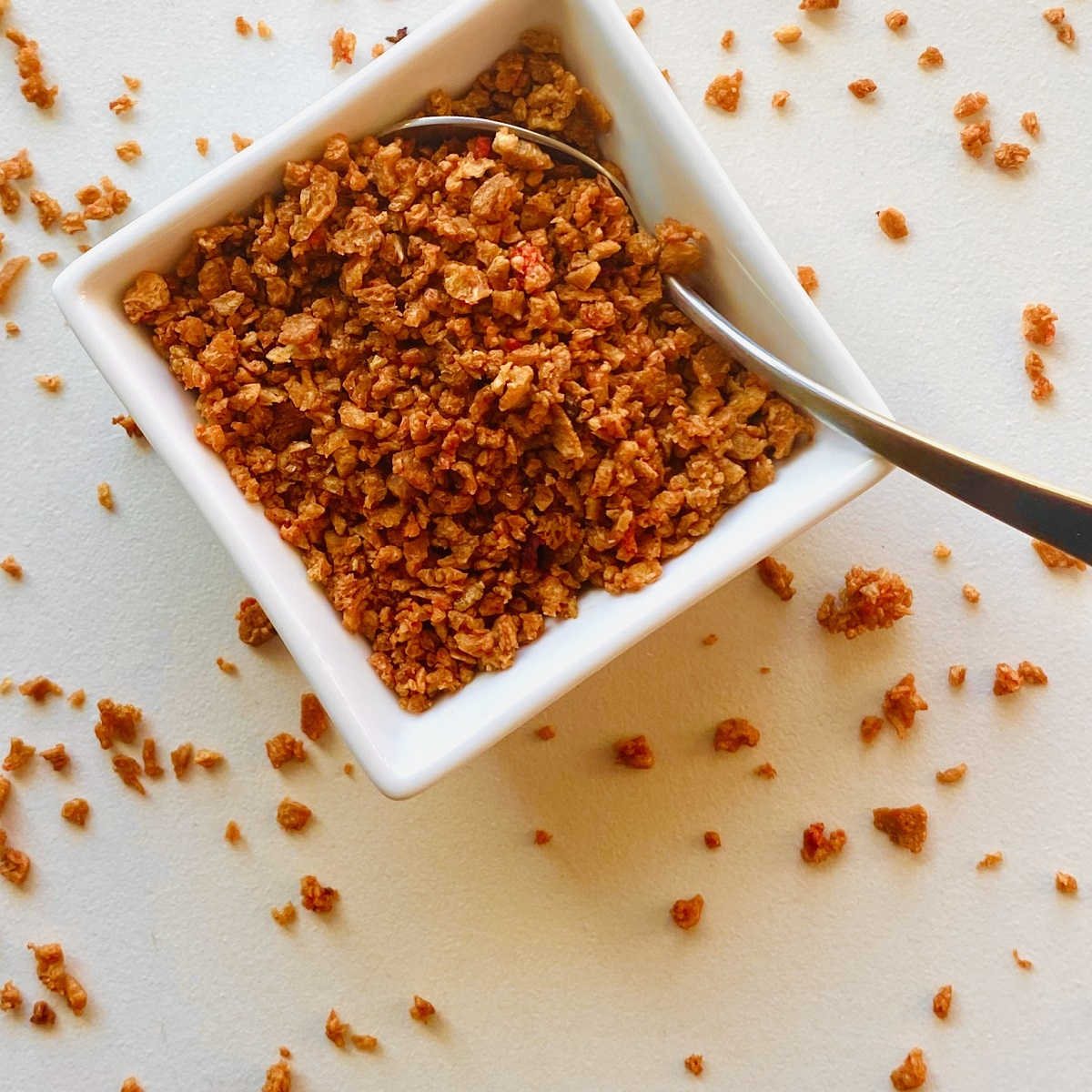 vegan bacon bits in white dish with spoon