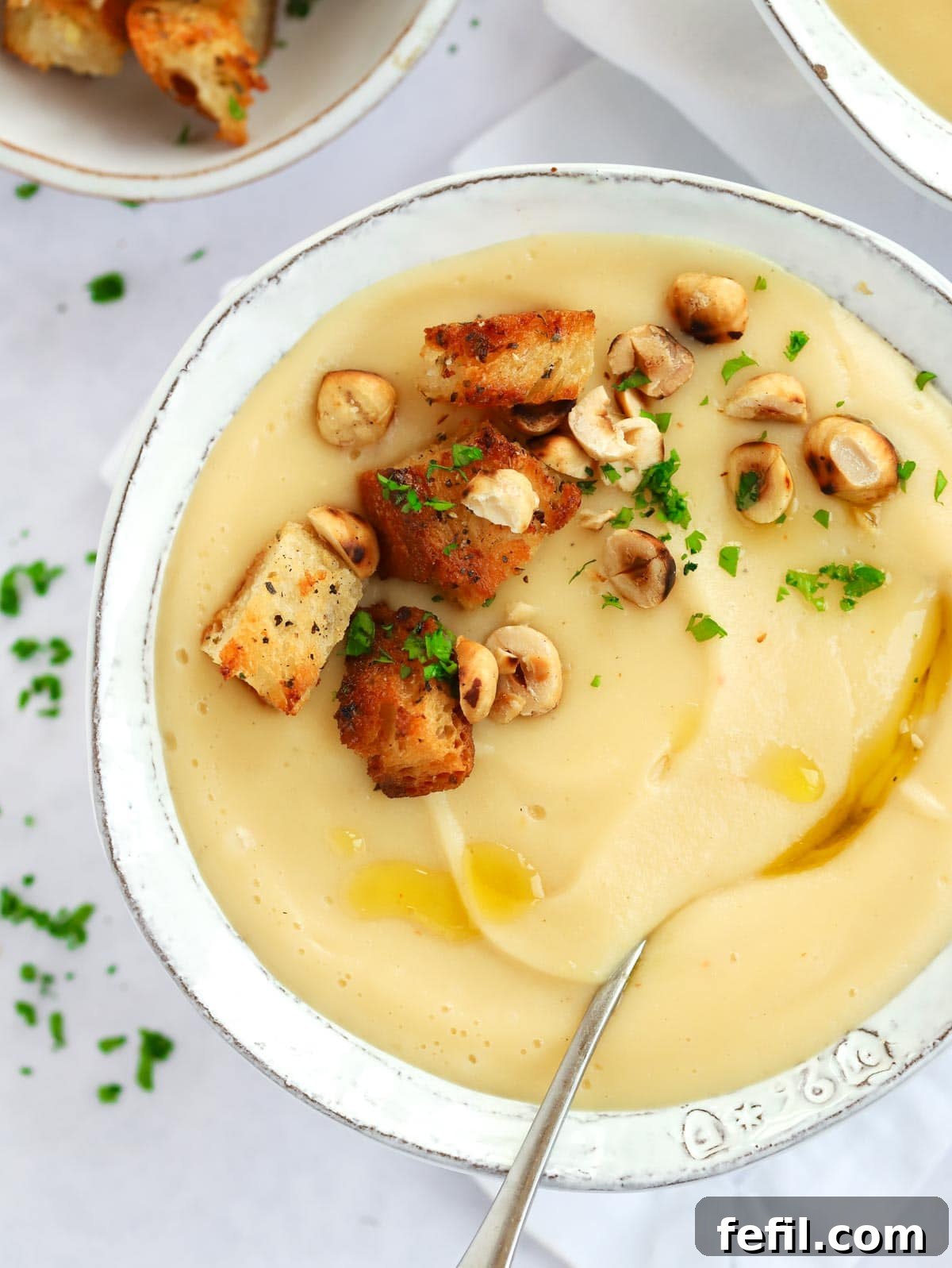 Simple 20 Minute Parsnip Soup 2 A bowl of Parsnip Soup with Garlic Bread Croutons on top.