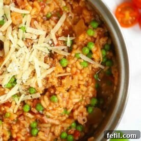 Baked Risotto recipe with bacon and cheese and peas, all in a big pan.