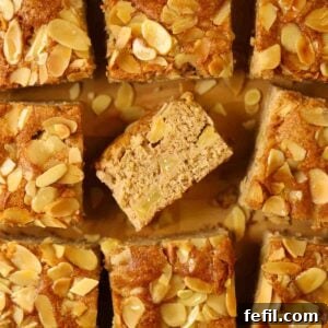 Homestyle Apple Cake 5 Squares of cooked apple cake with nutty topping.