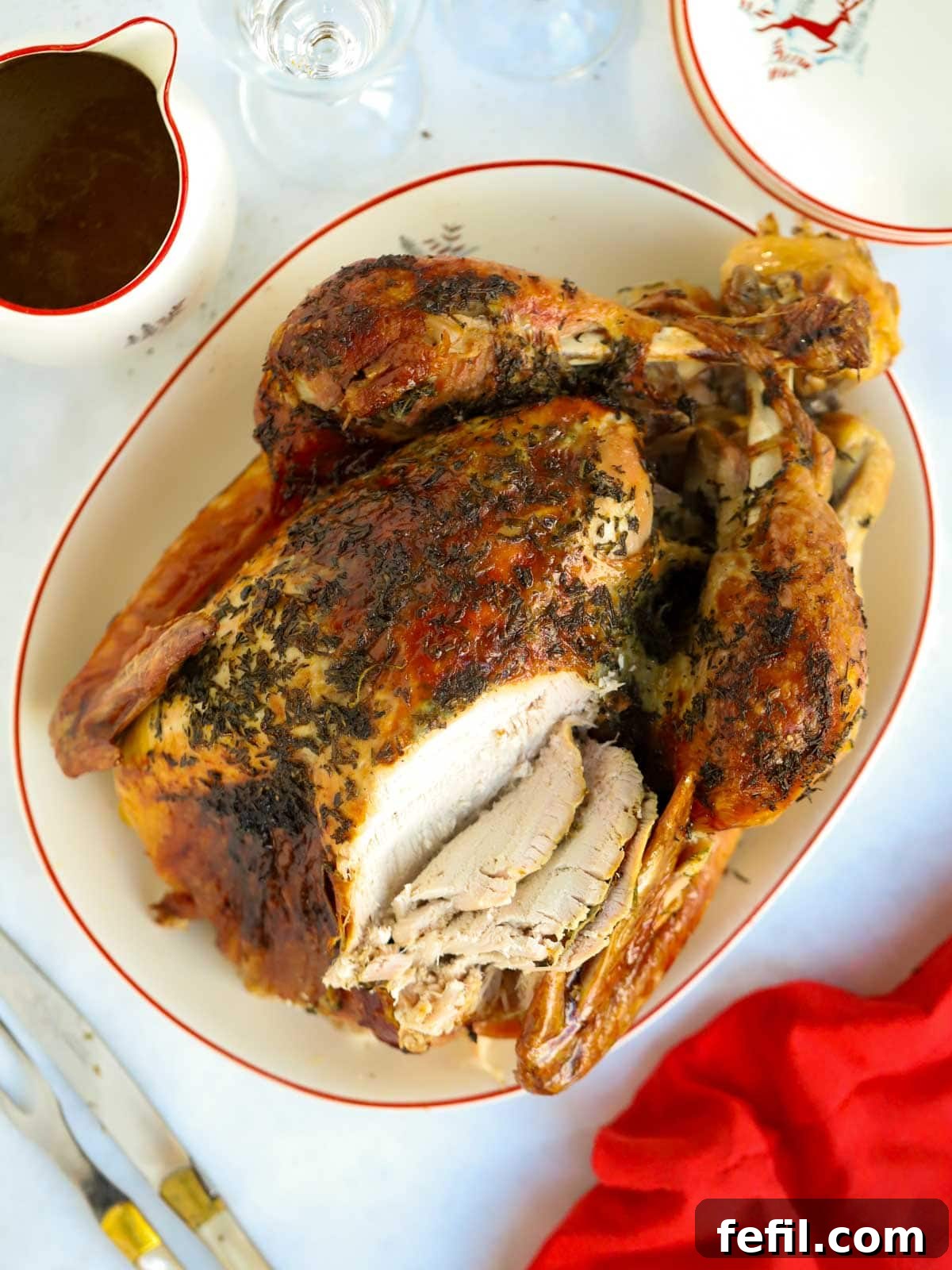 Easy Elegance Roast Turkey 2 A perfectly roasted whole turkey, partially carved, gracing a festive Christmas dinner table.