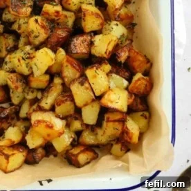 Close up of golden brown parmentier potatoes, a delicious and crunchy side dish, seasoned with herbs.