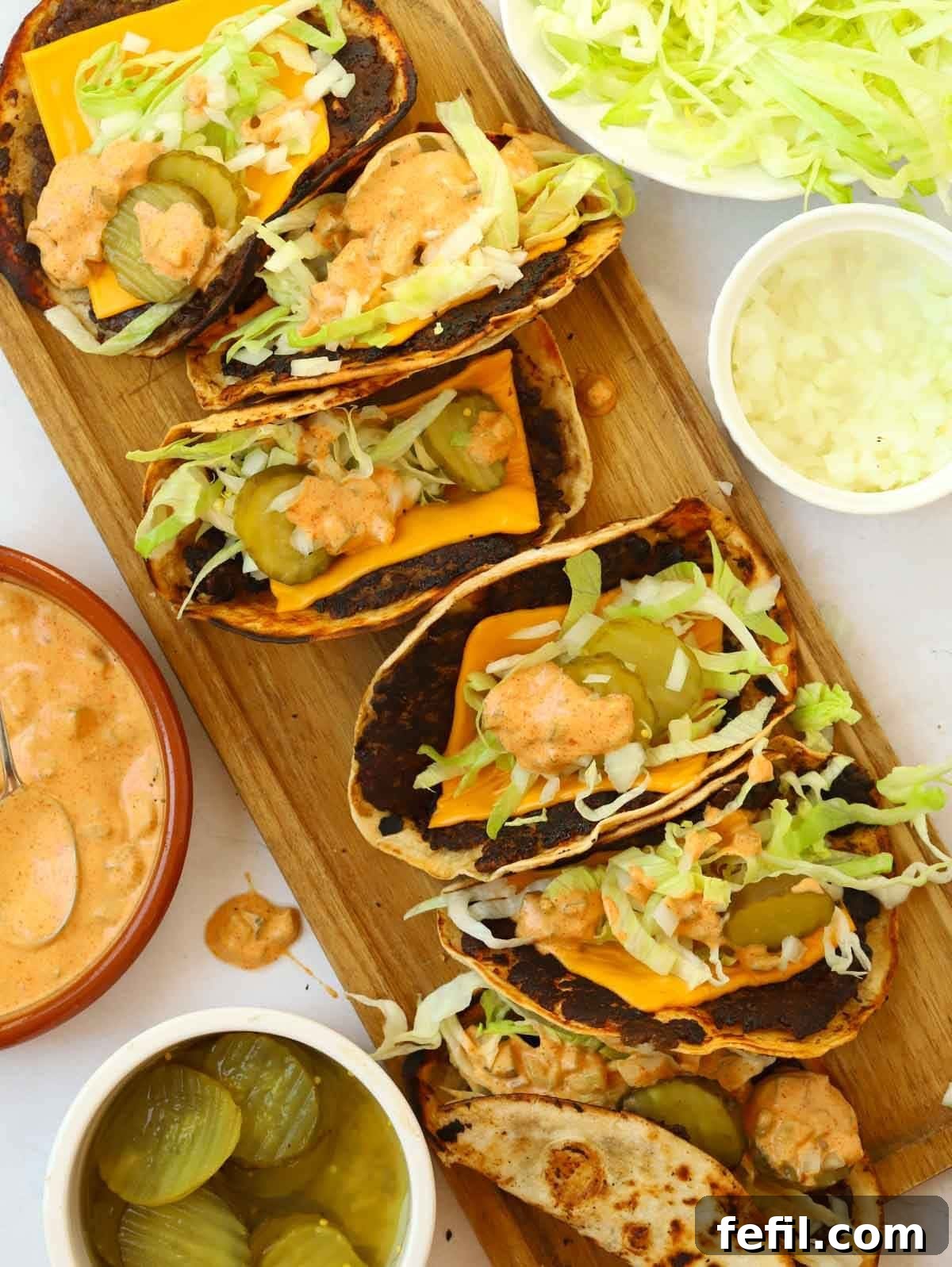 Big Mac Taco Mashup 2 A serving board filled with Big Mac Tacos and side dishes, showcasing their delicious toppings.