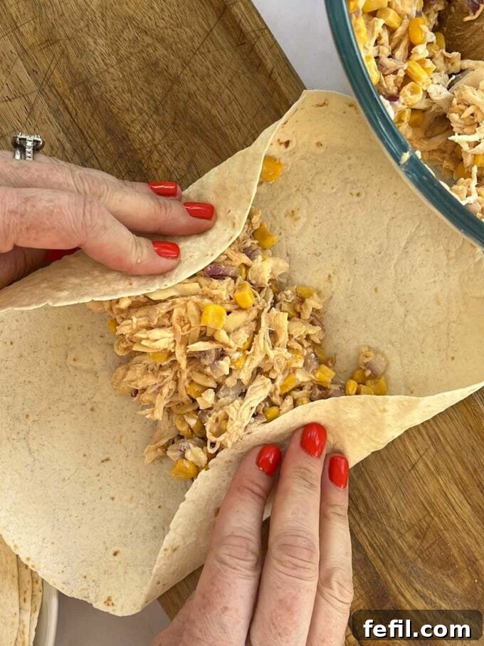 Step 3 in the recipe for Chicken Wraps. Fold the tortilla.