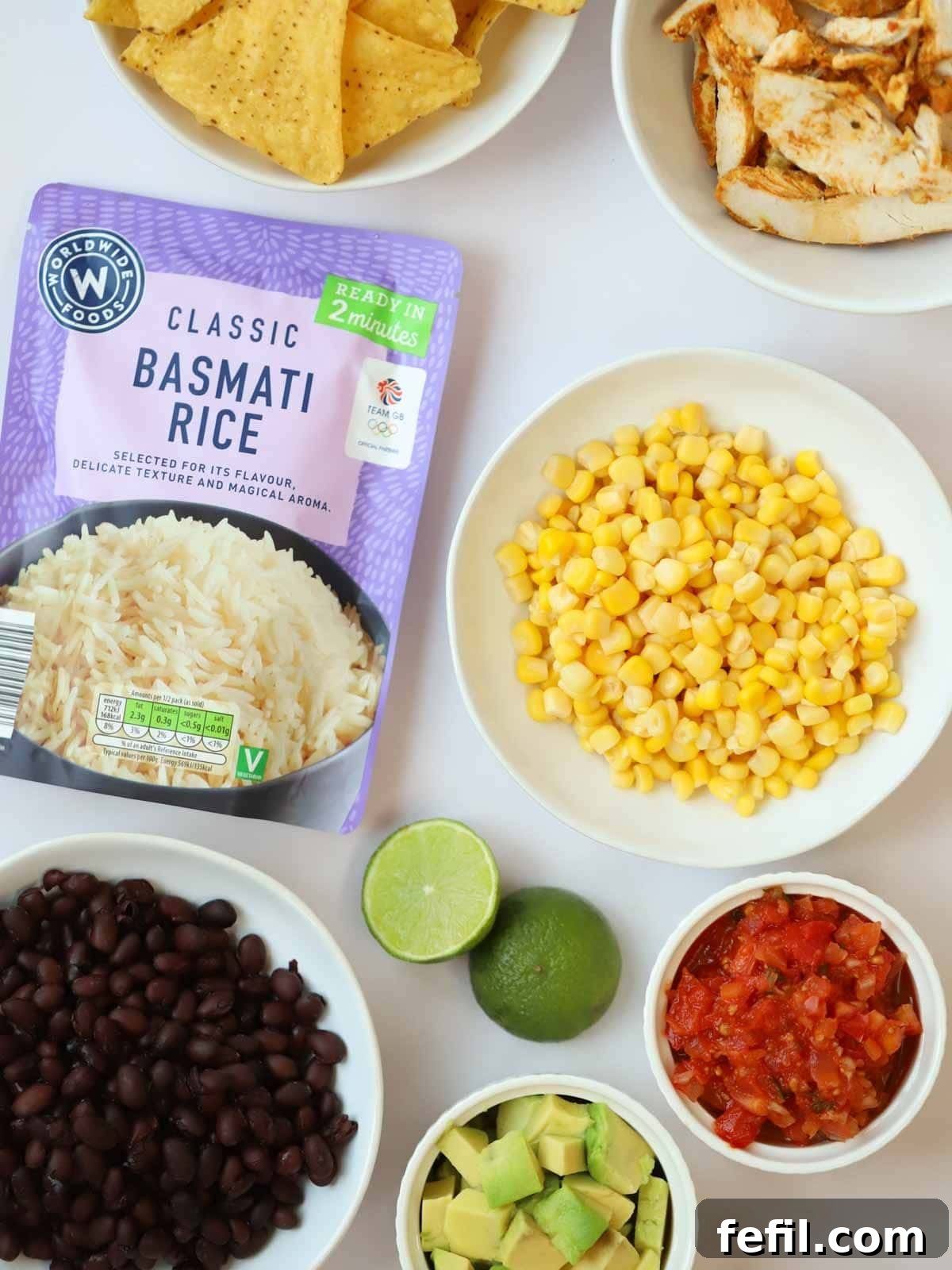 The vibrant ingredients for Burrito Bowls recipe laid out beautifully on a counter, ready for assembly.