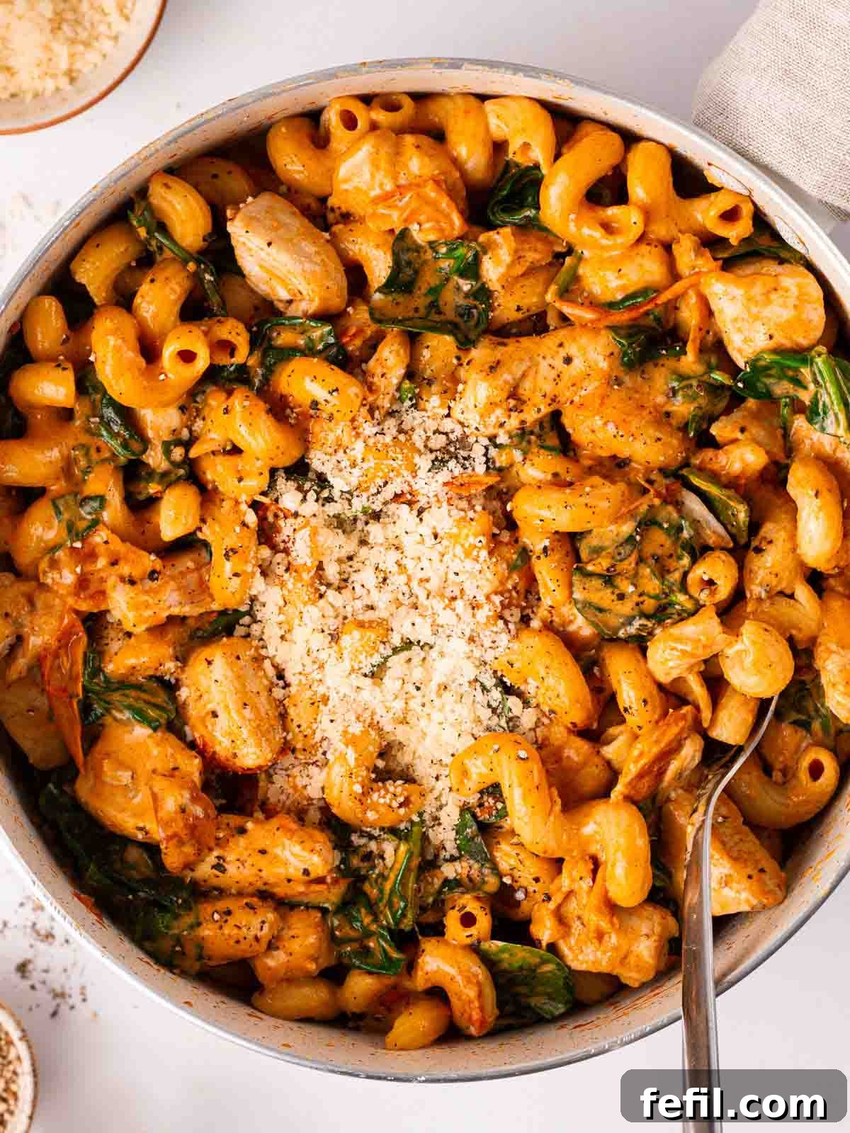 A large pan filled with creamy one-pot Marry Me Chicken Pasta, topped with fresh parmesan cheese and ready to be served directly from the pan.