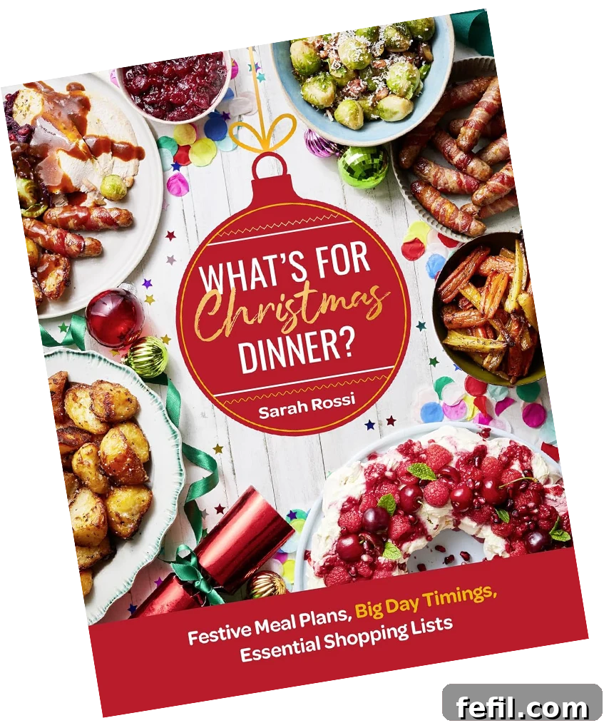 A person holding a cookbook titled 'What’s For Christmas Dinner?'