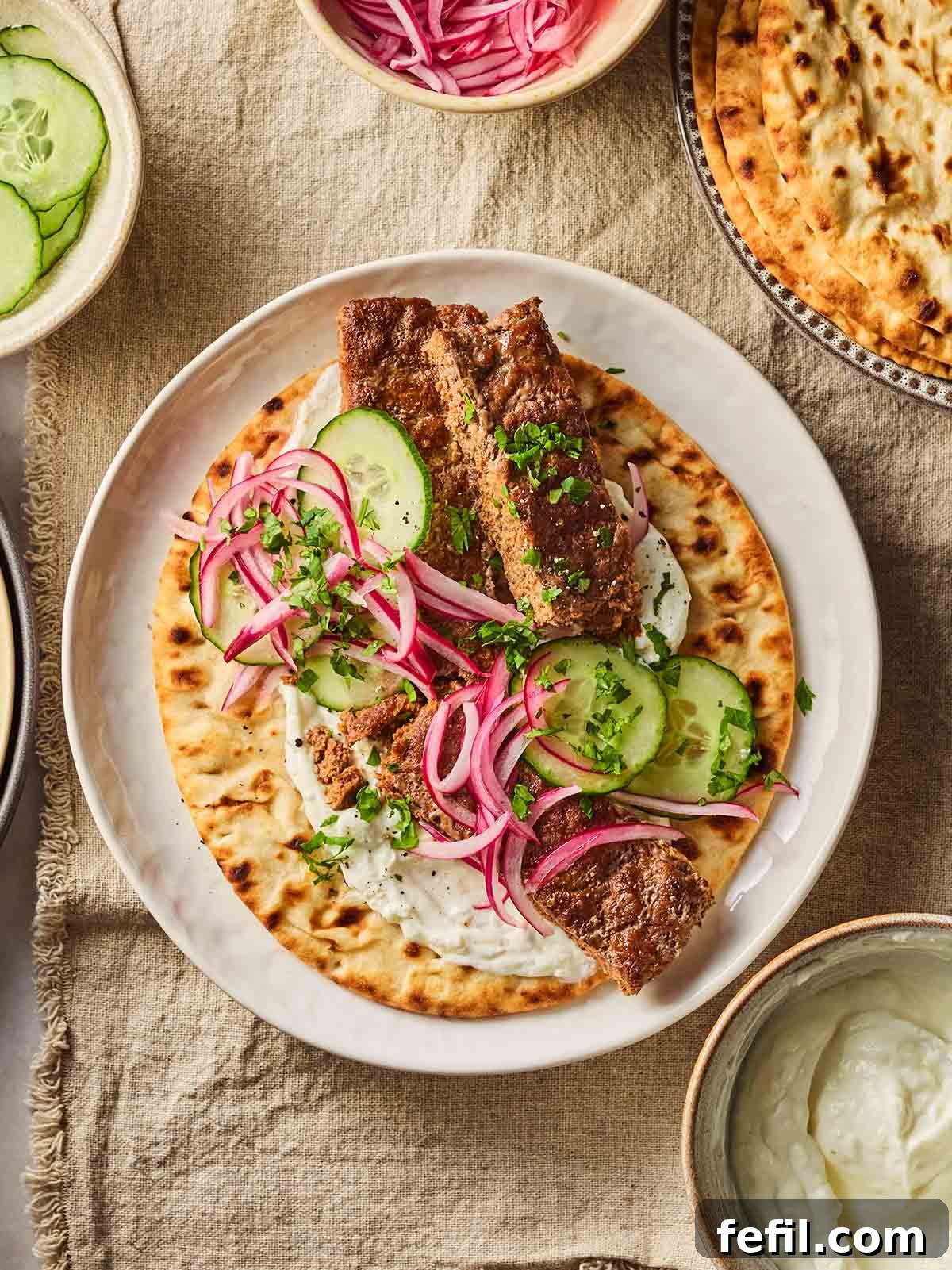A homemade kebab with salad and sheet pan beef mince inside, on a table, set and ready to eat.