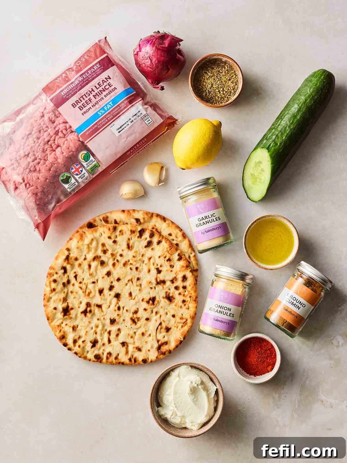The ingredients for making a sheet pan kebab laid out in a white surface.