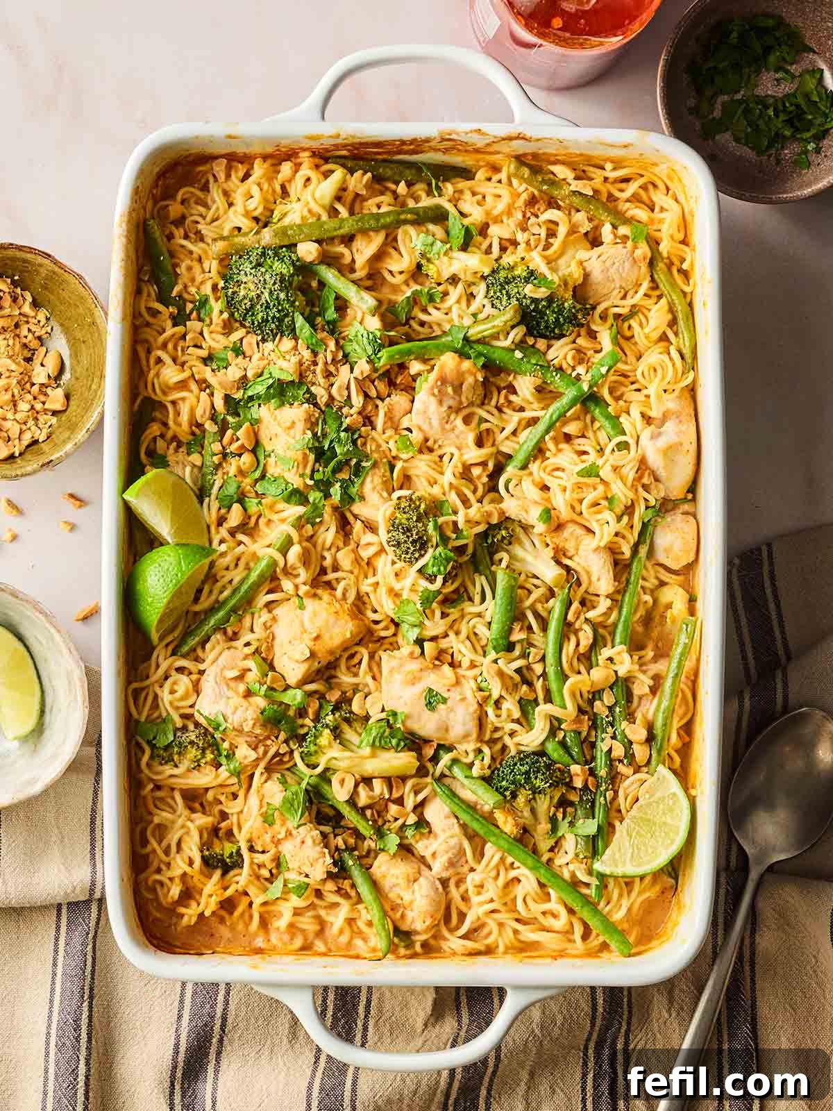 Spicy Peanut Chicken Noodles 2 An oven dish filled with a one pan dish of chicken, noodles and vegetables.