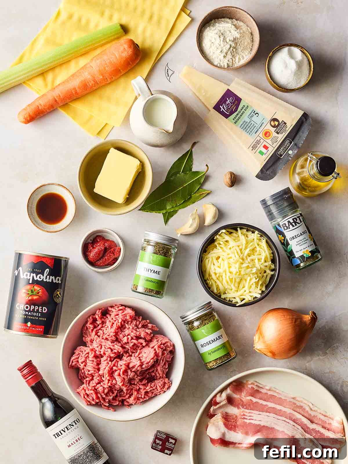 The Ultimate Classic Lasagne 4 The ingredients for a classic lasagne recipe laid out on a white surface.