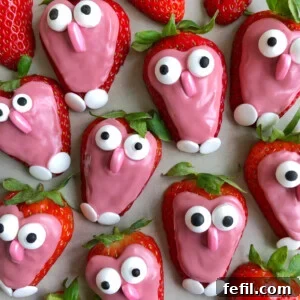 Strawberries dipped in pink icing with candy eyes and fondant noses and feet, these adorable bites make for fun food recipes that look like cute, cartoonish characters.