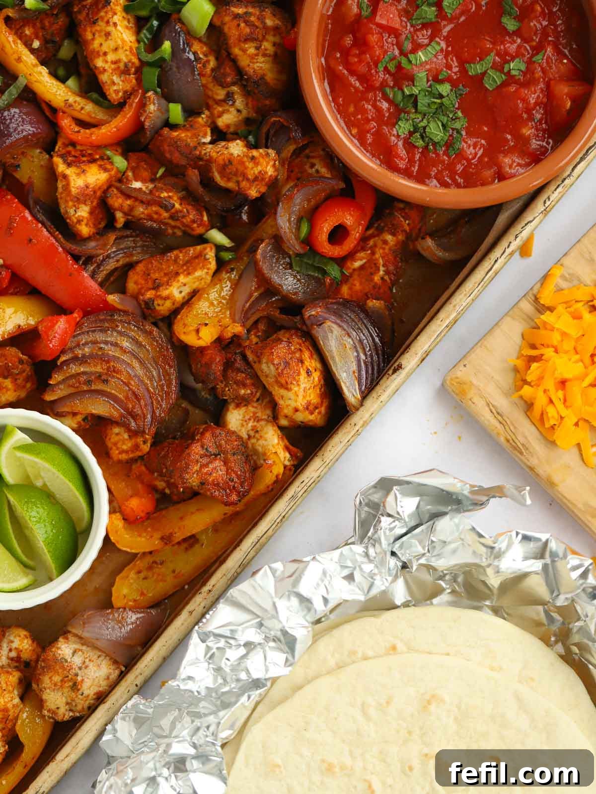 Chicken fajitas with tortillas cheese and salsa.