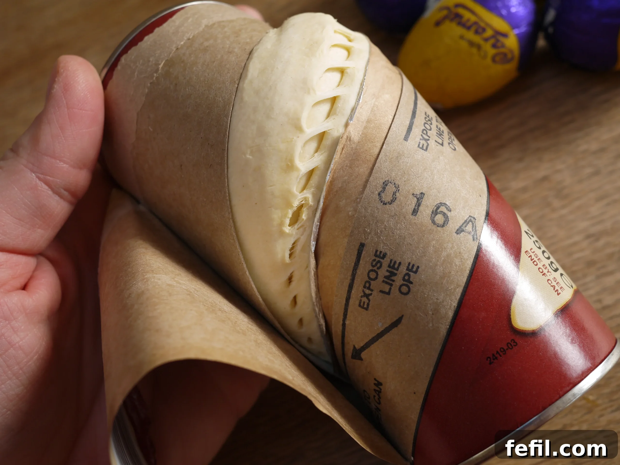 Opening a tube of ready-made croissant dough, a satisfying culinary step.