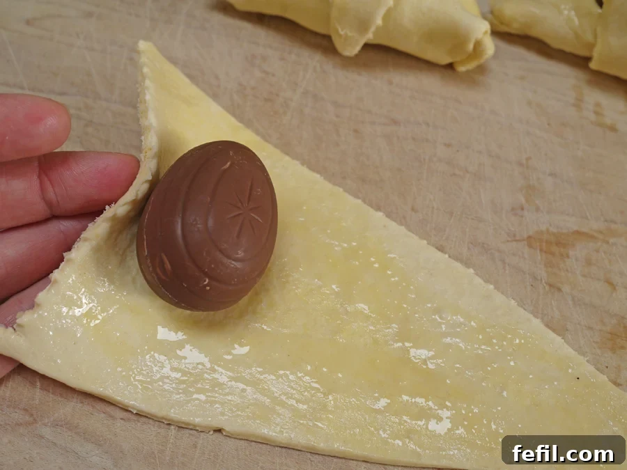 Rolling out croissant dough and stuffing it with frozen Cadbury Caramel Eggs.