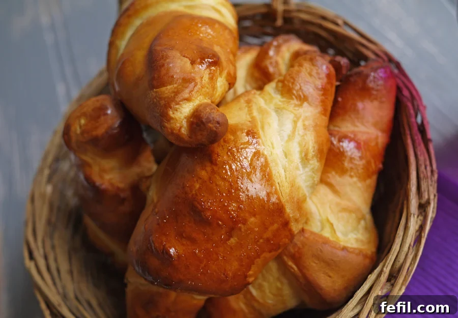 A close-up of a warm, gooey Cadbury Caramel Egg Croissant with caramel dripping.