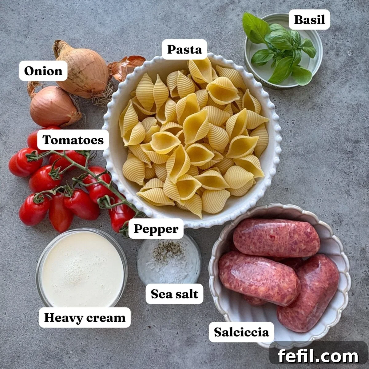 Spicy Italian Sausage Pasta Recipe 4 Ingredients for Spicy Italian Sausage Pasta featuring bowls of pasta, Italian sausages, onion, heavy cream, tomatoes, fresh basil, sea salt, and pepper.