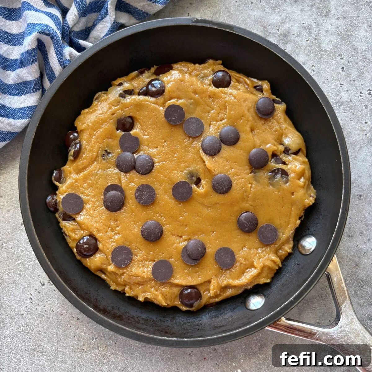 Gooey Chocolate Chip Skillet Cookie Recipe 3 An unbaked pizookie in a small skillet is ready to be baked.
