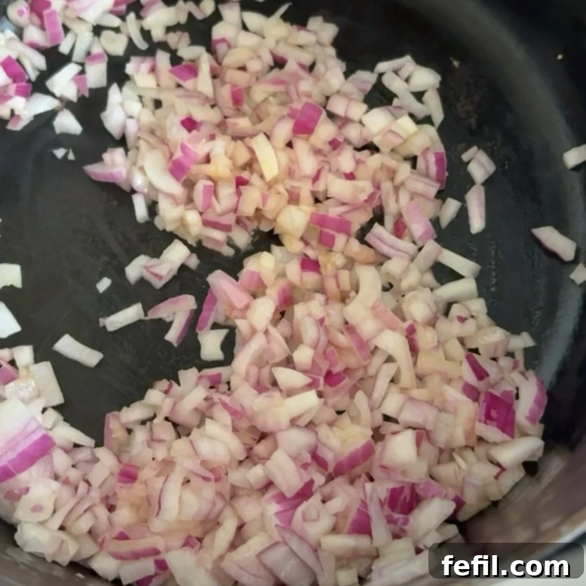 Spooky Halloween Spaghetti with Creepy Meatball Eyes 4 Chopped red onion sautéing in butter in a medium saucepan.